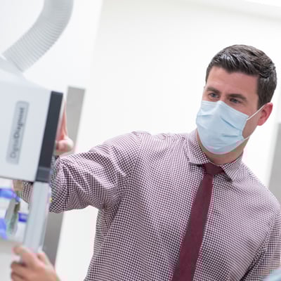 Hazelwood with new machine wearing mask