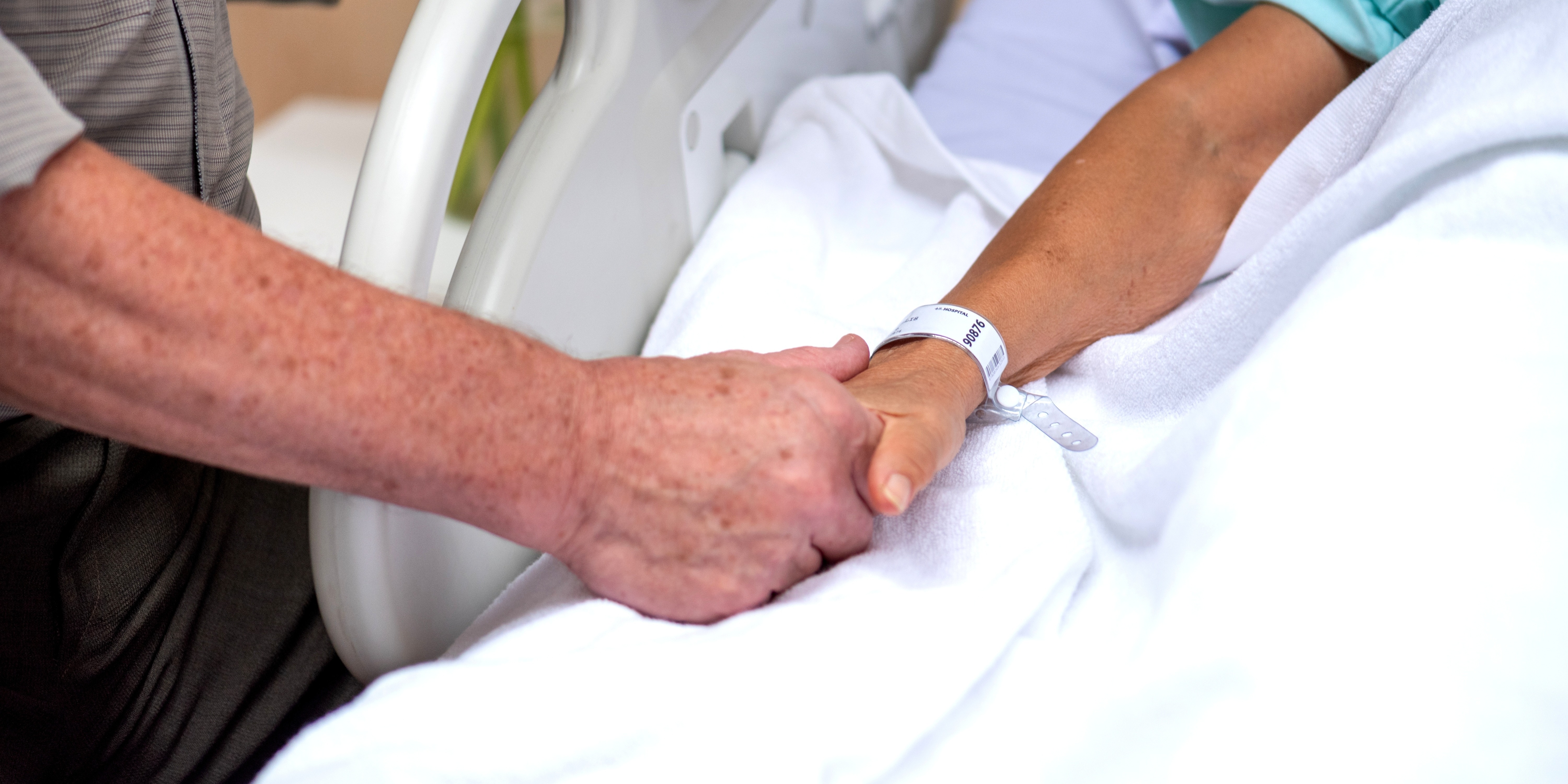 hospital bed holding hands